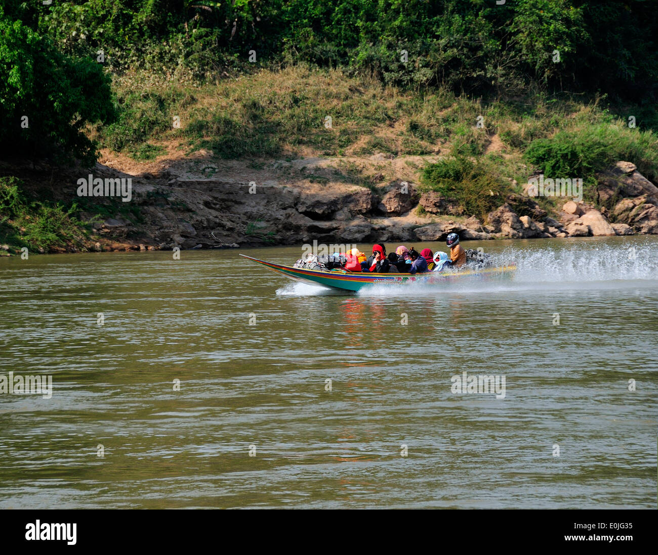 Fast dangerous  speedboat travelling between Huay Xai and Luang Prebang on the Mekong in Northern Laos, Lao, Southeast Asia Stock Photo