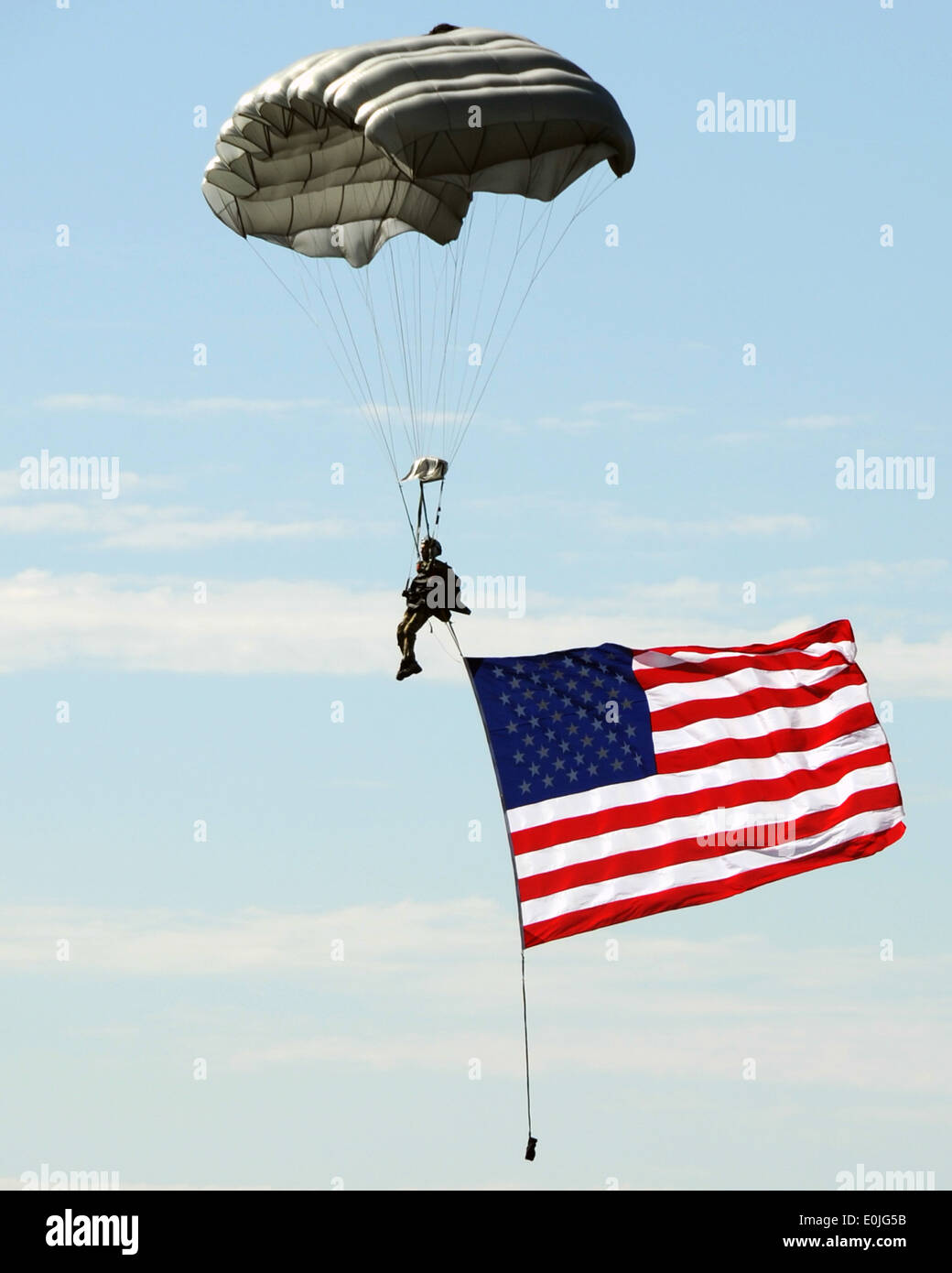 JOINT BASE LEWIS-MCCHORD, Wash. – An Airman parachutes to the ground from a C-17 Globemaster III while streaming an American Stock Photo