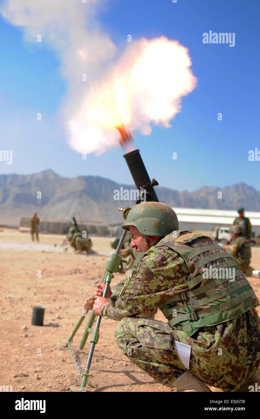 An Afghan National Army soldier with the Heavy Weapons Platoon, 6th Kandak, braces himself, as a round fires from an 82mm morta Stock Photo
