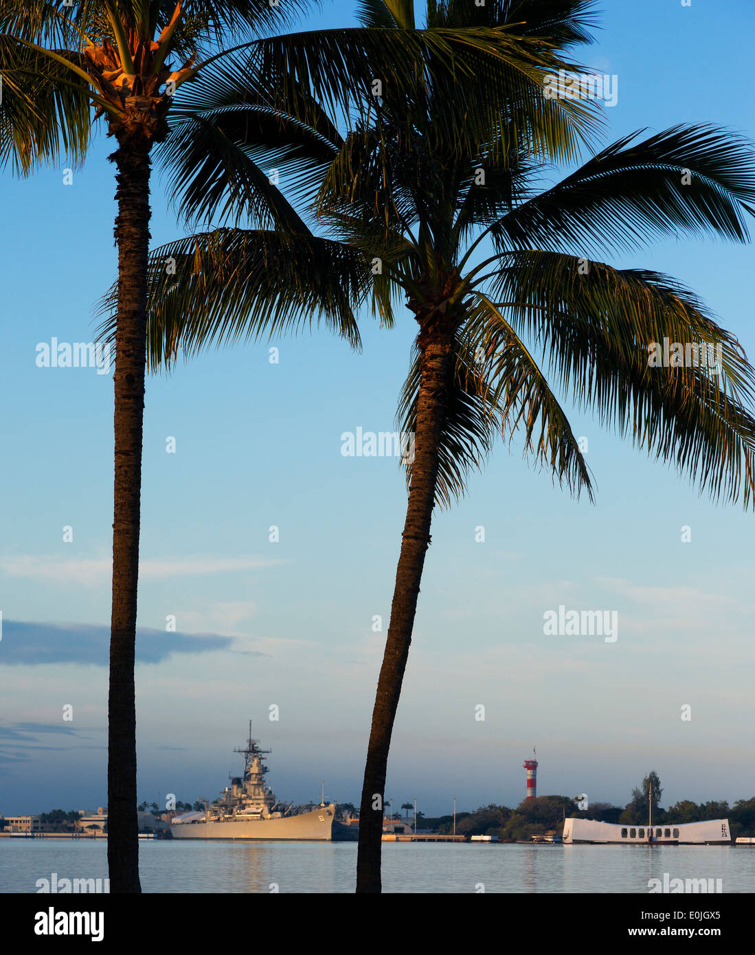 Palm trees and USS Arizona Memorial and USS Missouri battleship 63 at Pearl Harbor, Oahu, Hawaii Stock Photo