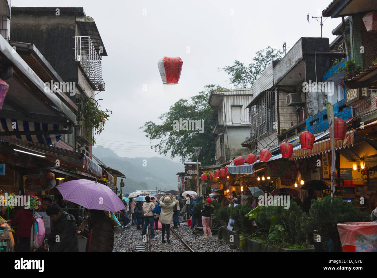 Releasing sky lantern (Kongming lantern) on the old street during Chinese Lantern Festival, Shifen, Pingxi, Taiwan Stock Photo