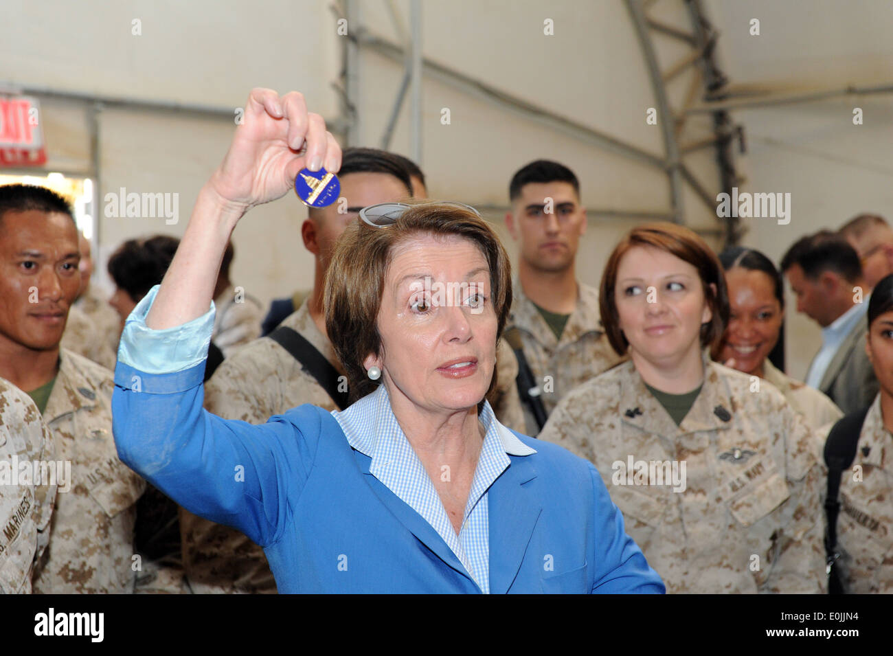 House Democratic Leader, Nancy Pelosi (D-Calif.) displays a congressional coin to troops on Camp Leatherneck during a Mother's Stock Photo