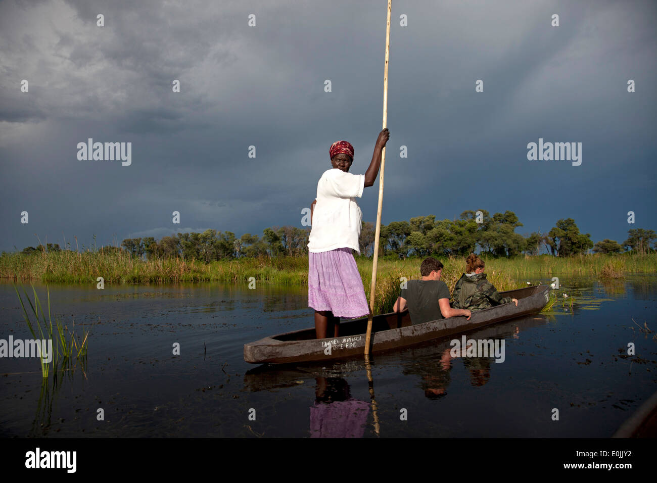 Poler on their traditional mokoro boat in the Okavango Delta, Botswana, Africa Stock Photo
