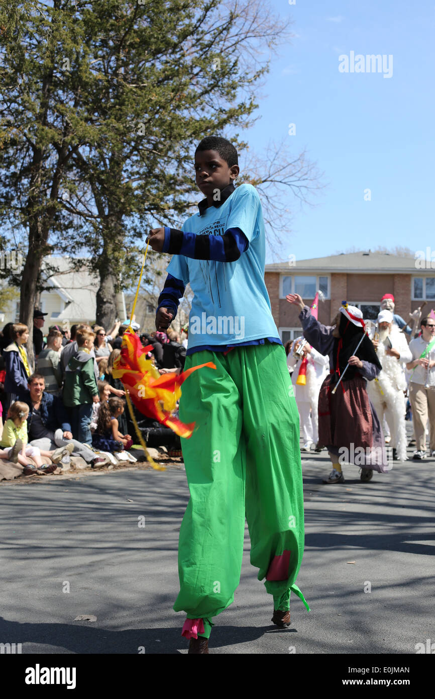 A boy walking on stilts at the May day parade in Minneapolis, Minnesota