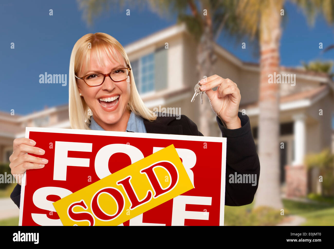 Excited Woman Holding House Keys and Sold Real Estate Sign in Front of ...