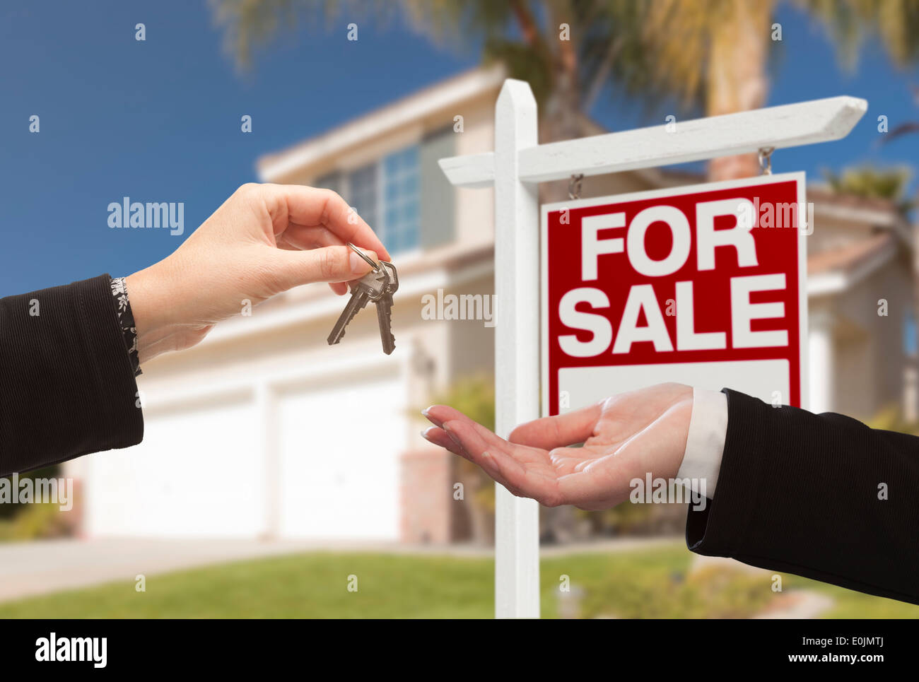 Real Estate Agent Handing Over the House Keys in Front of a Beautiful ...
