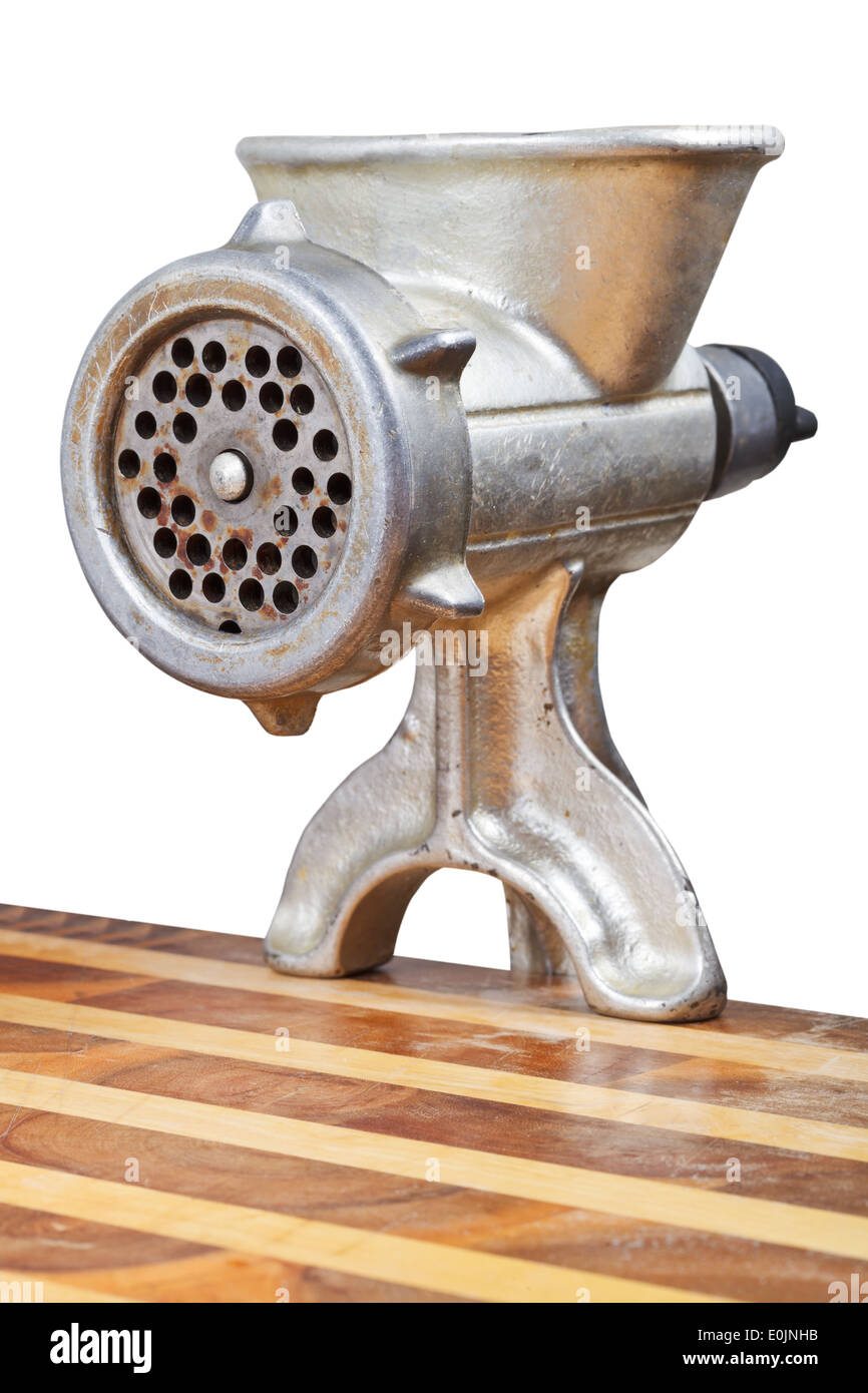 old iron meat mincer inslalled on table isolated on white background