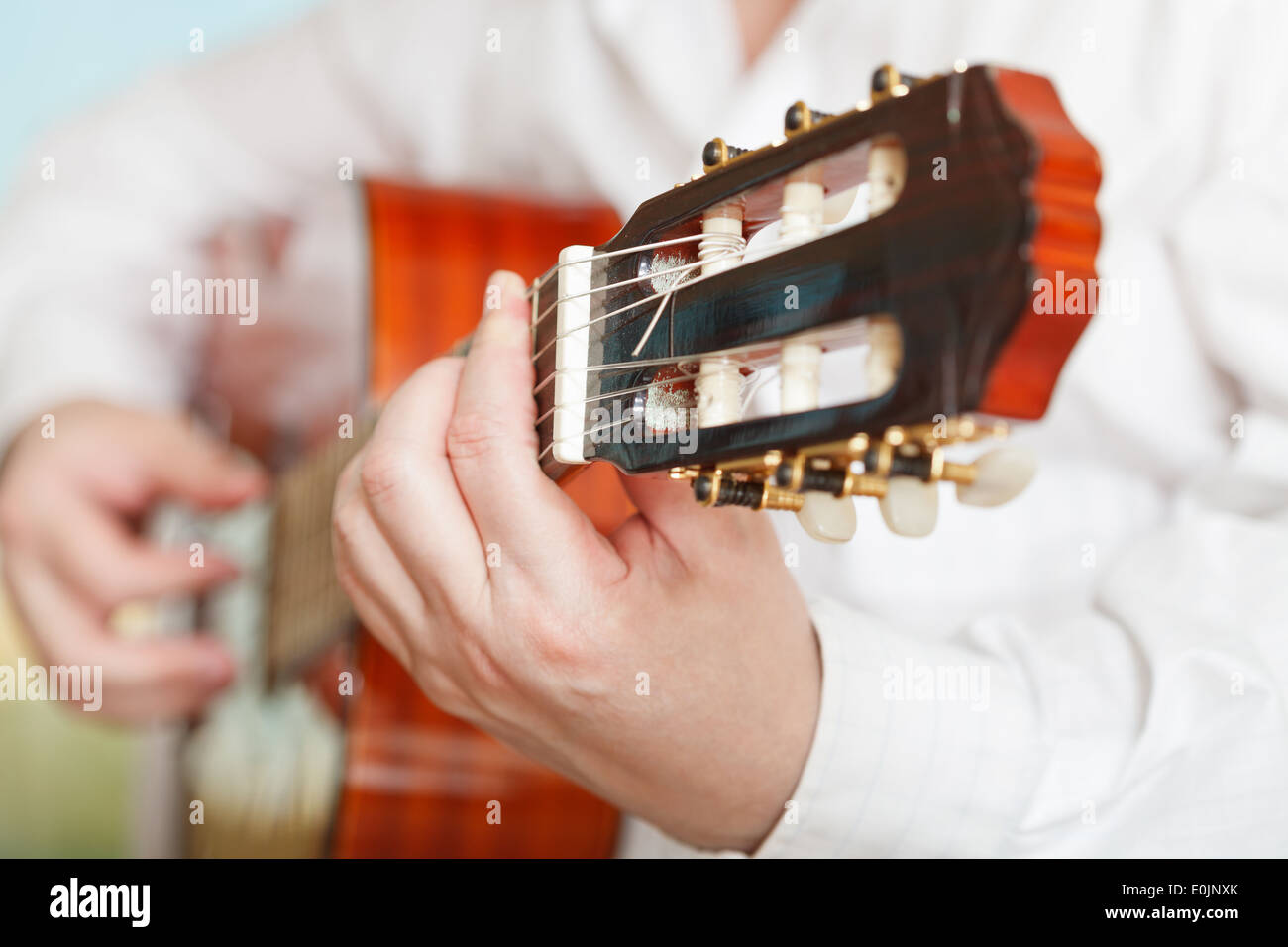 man plays on prime acoustic guitar close up Stock Photo