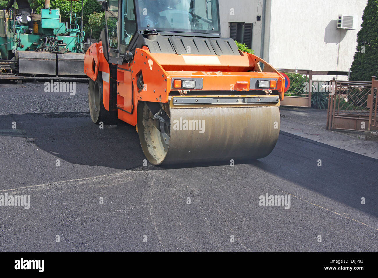 Compactor roller during road construction at asphalting work Stock