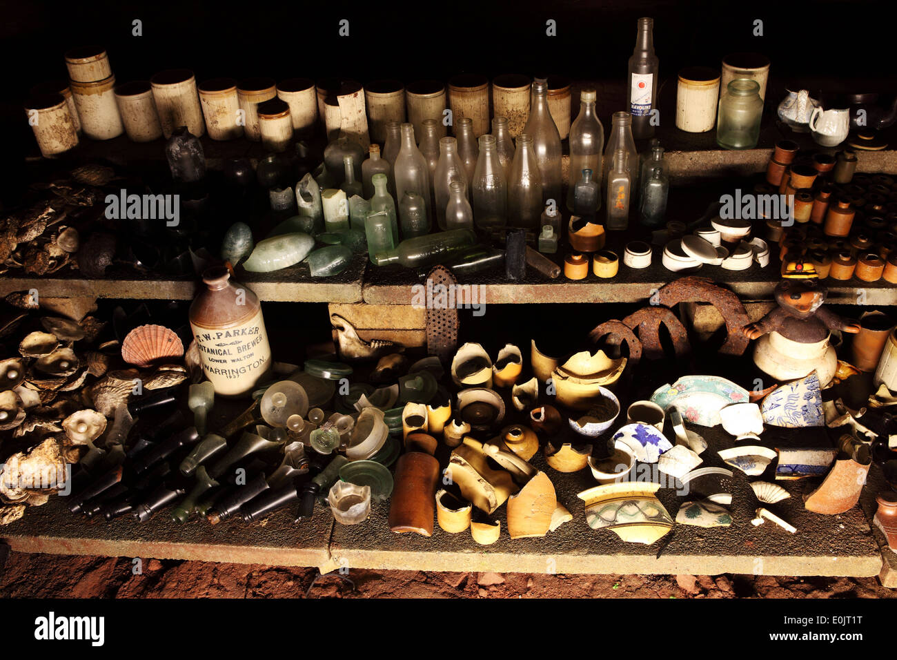 Crockery, bottles and recovered items on display within the Williamson Tunnels in Liverpool, United Kingdom. Stock Photo