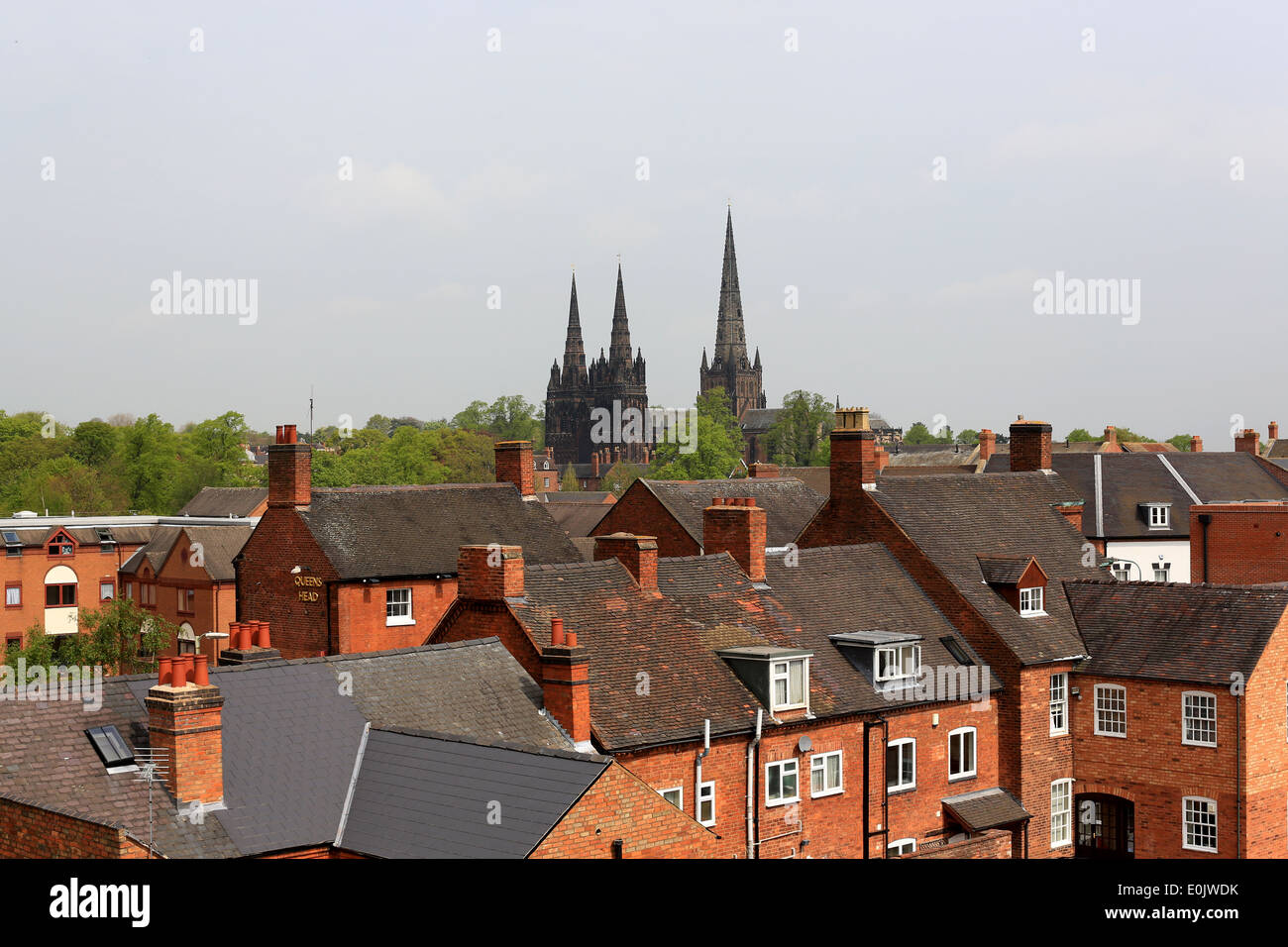 Lichfield Cathedral in Lichfield City Centre, Staffordshire, showing the roofs of the older buildings and the three spires Stock Photo