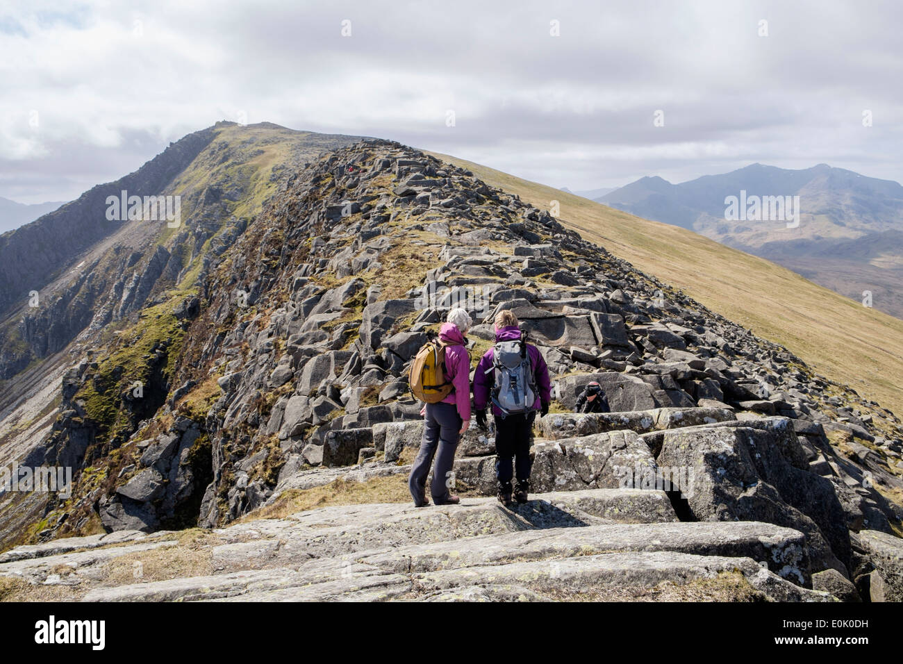 Two hikers on Carnedd Moel Siabod mountain top north ridge with view to summit in mountains of Snowdonia National Park (Eryri) North Wales UK Britain Stock Photo