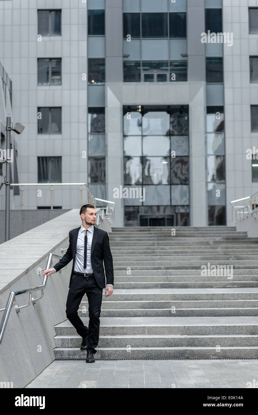 Strict businessman. Side view of a full-length attractive young man in suit and tie lasicheskom Stock Photo