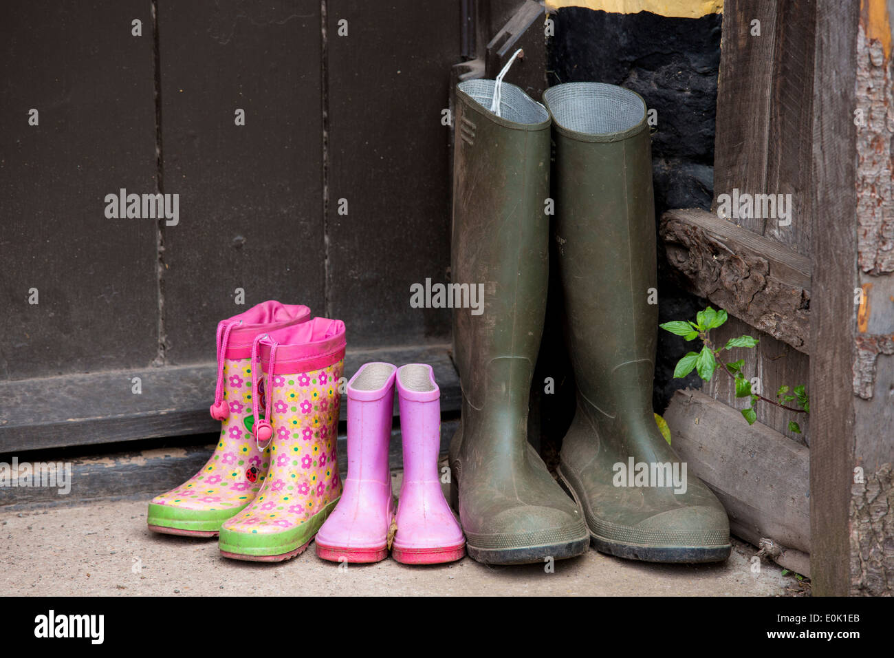 Wellington boots at front door of cottage in Bossington in Exmoor, Somerset, United Kingdom Stock Photo