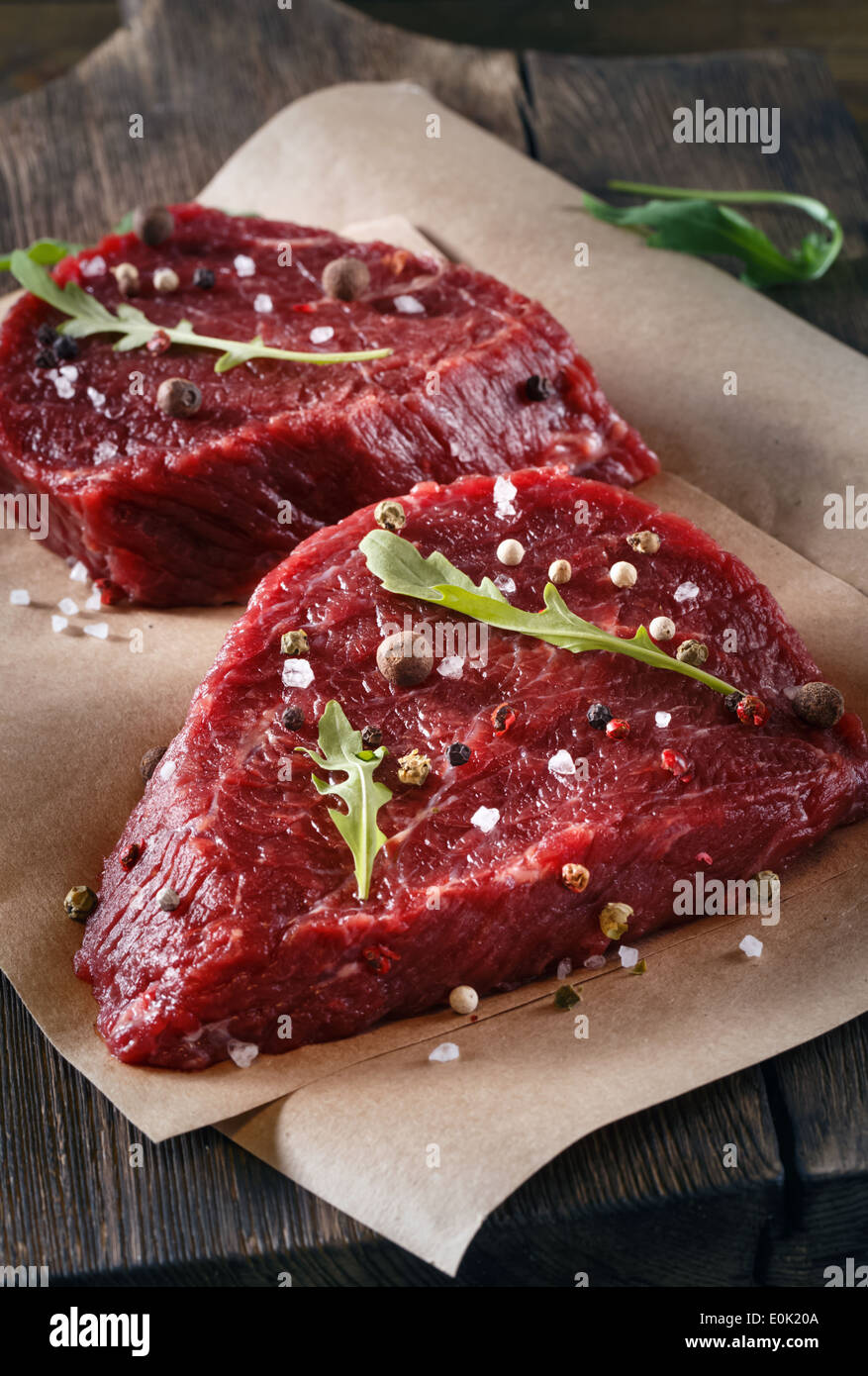 Succulent tender raw lean beef steaks lying on a sheet Stock Photo