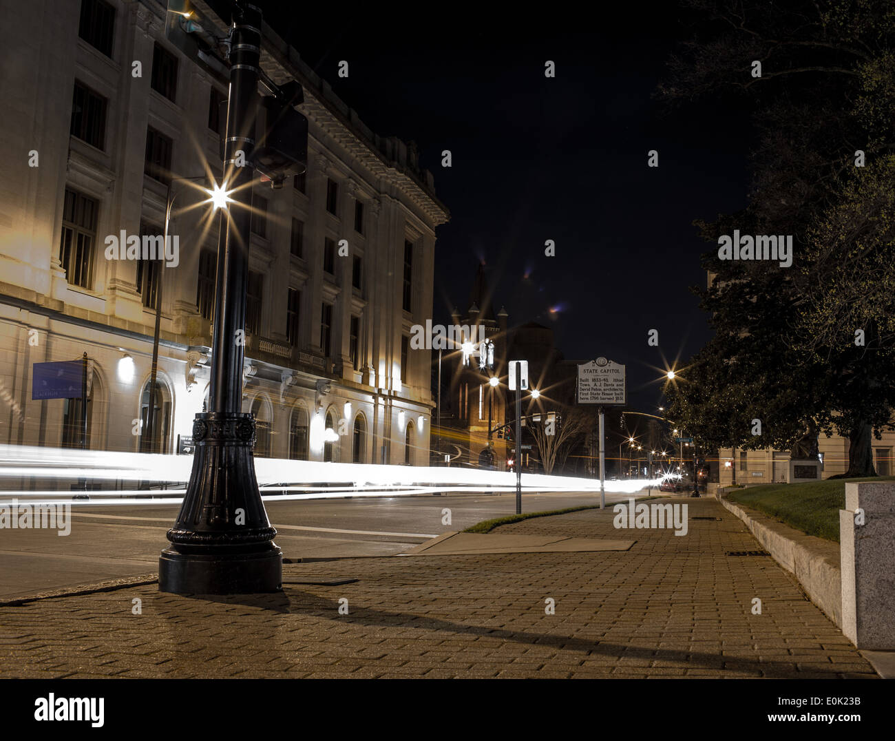 Downtown City at night with lights from cars passing by Stock Photo