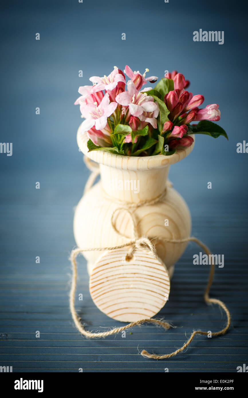 Weigela blooming beautiful wood vase on the table Stock Photo Alamy