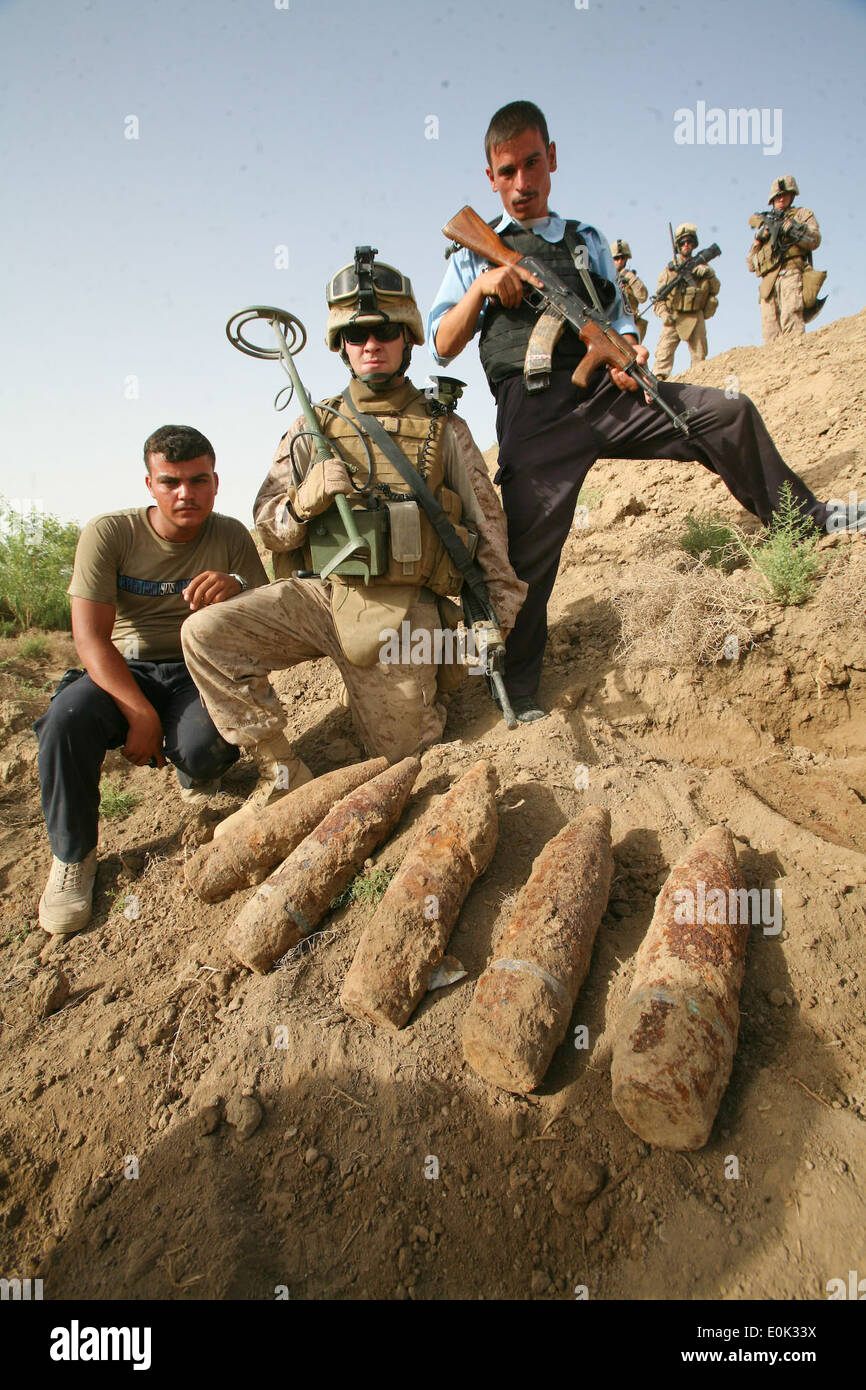 A U.S. Marine engineer attached to Alpha Company, 1st Battalion, 7th Marine Regiment and Iraqi policemen pose with artillery ro Stock Photo