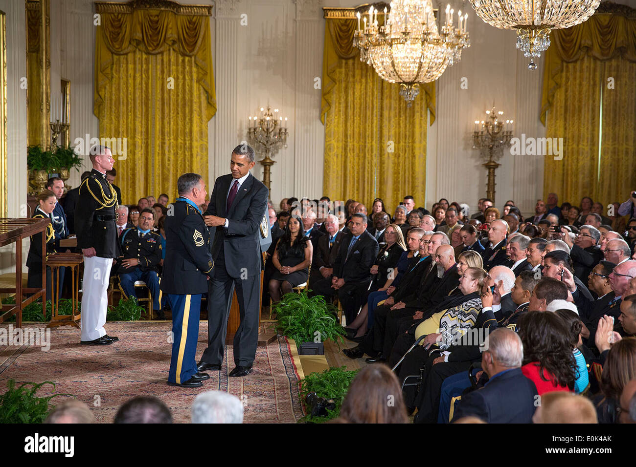 US President Barack Obama presents the Medal of Honor to Sergeant First Class Jose Rodela during the Medal of Honor ceremony in the East Room of the White House March 18, 2014 in Washington, DC. Stock Photo