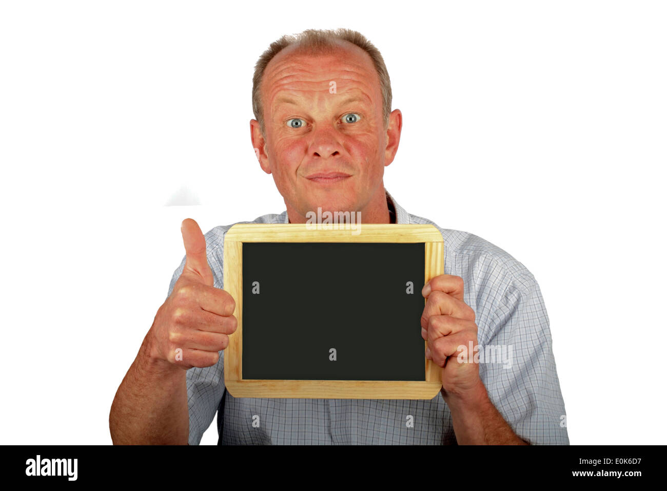 Man holding an empty black board and putting thumbs up Stock Photo