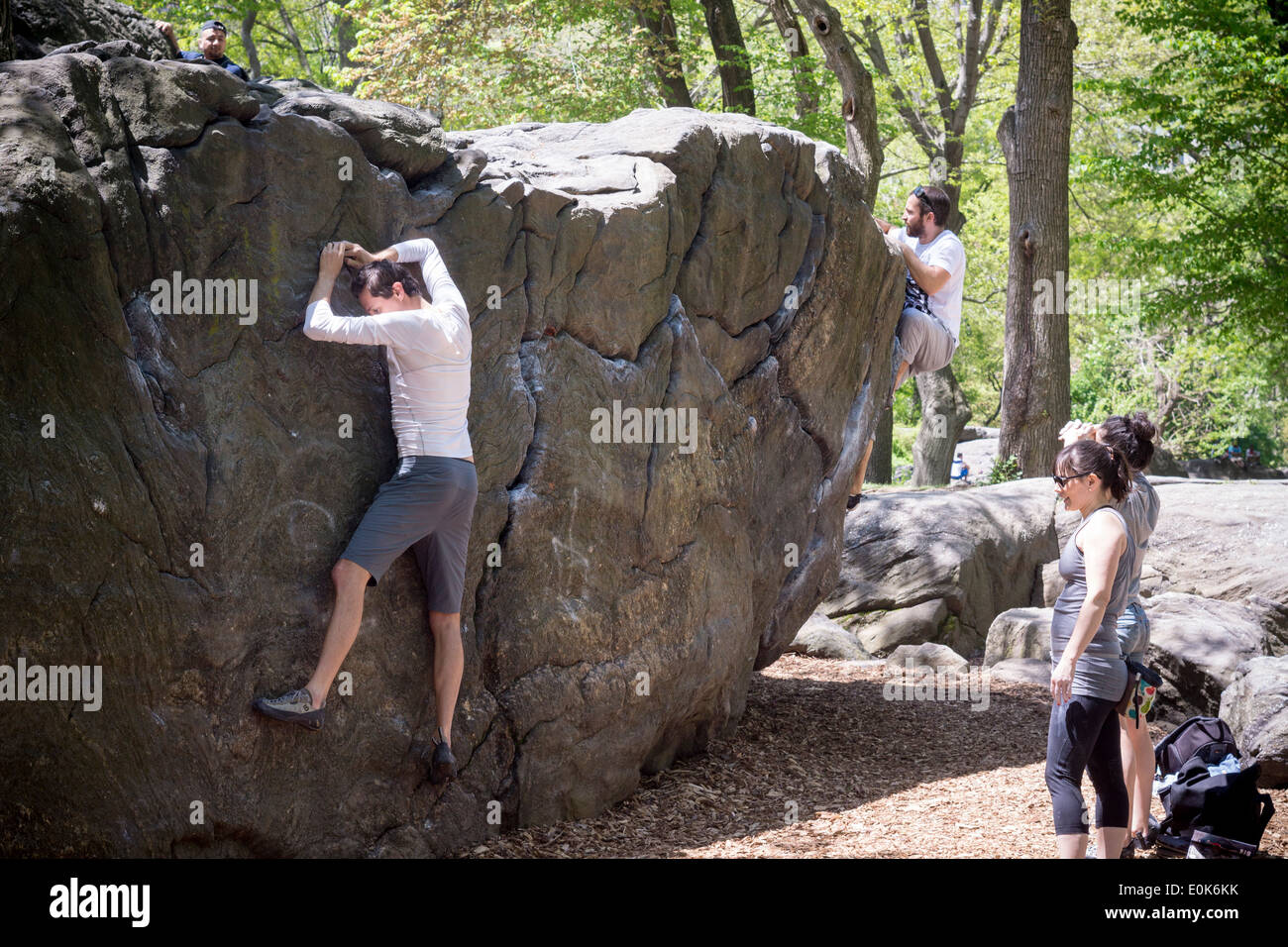 Bouldering enthusiasts on Rat Rock in Central Park in New York on