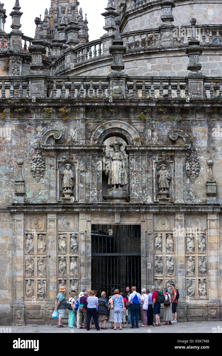 Tourists and tour guide at Quintana de Mortos gate of Cathedral of Santiago de Compostela, Galicia, Spain Stock Photo