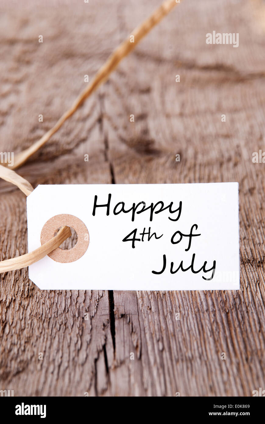 A White Banner on Wood with the Words Happy 4th Of July Stock Photo