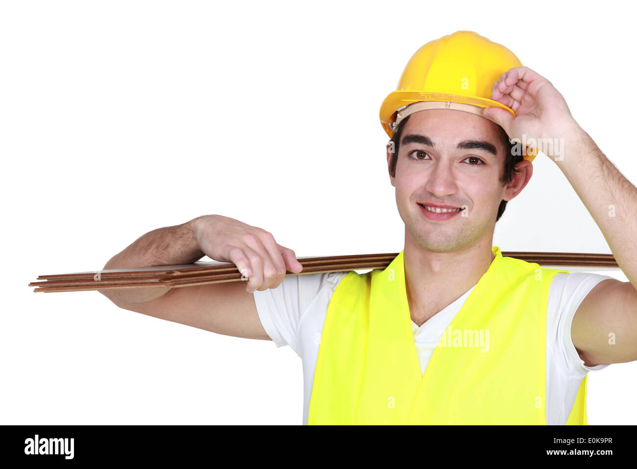 Construction worker carrying plywood Stock Photo