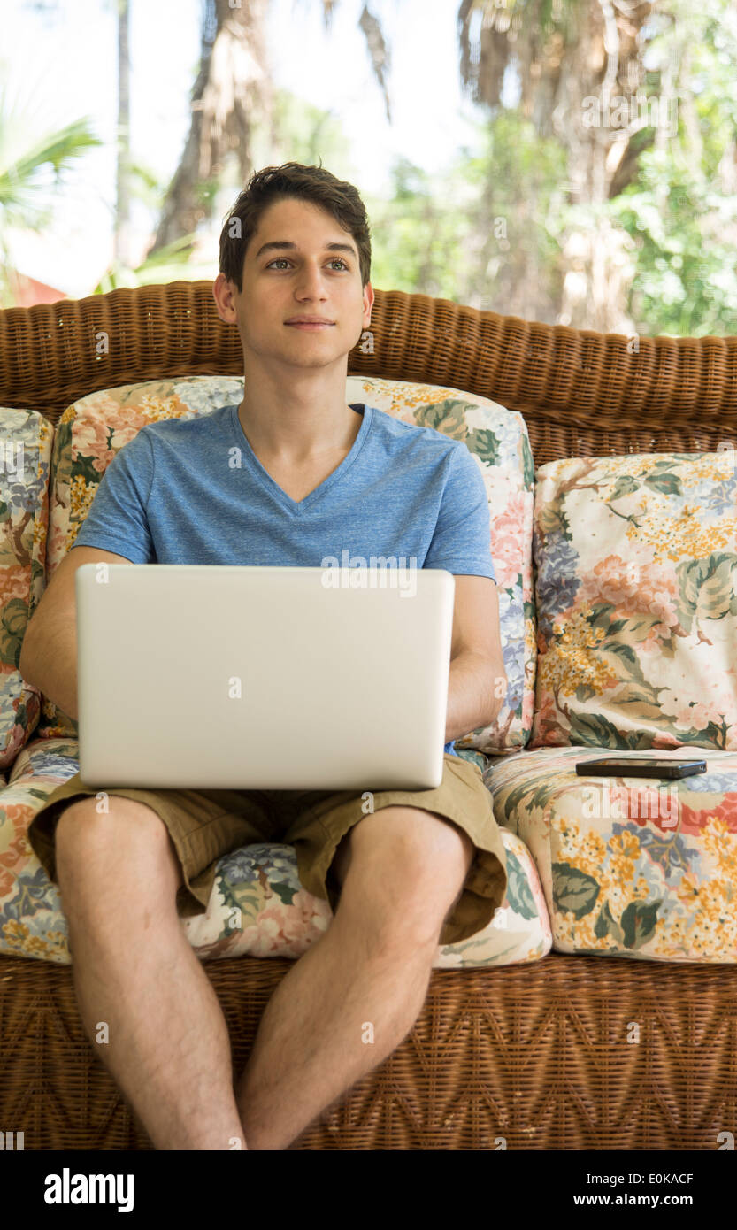 Young man using a portable computer at home Stock Photo