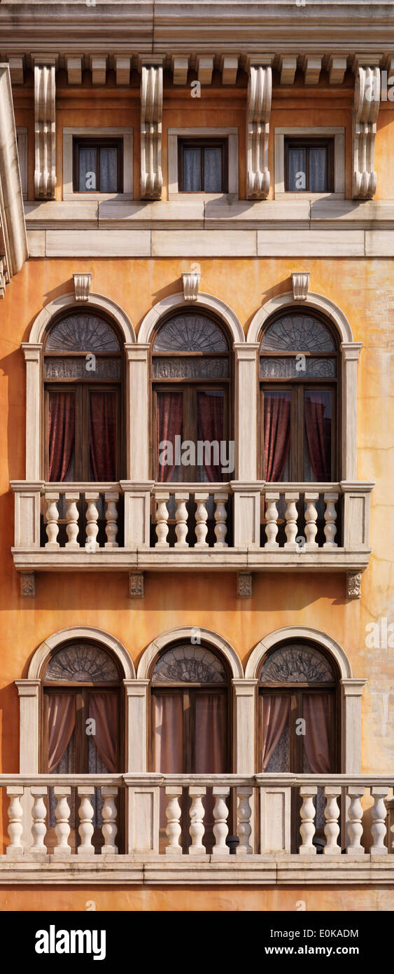 Arched windows of a house texture. Venetian gothic architectural style. Stock Photo