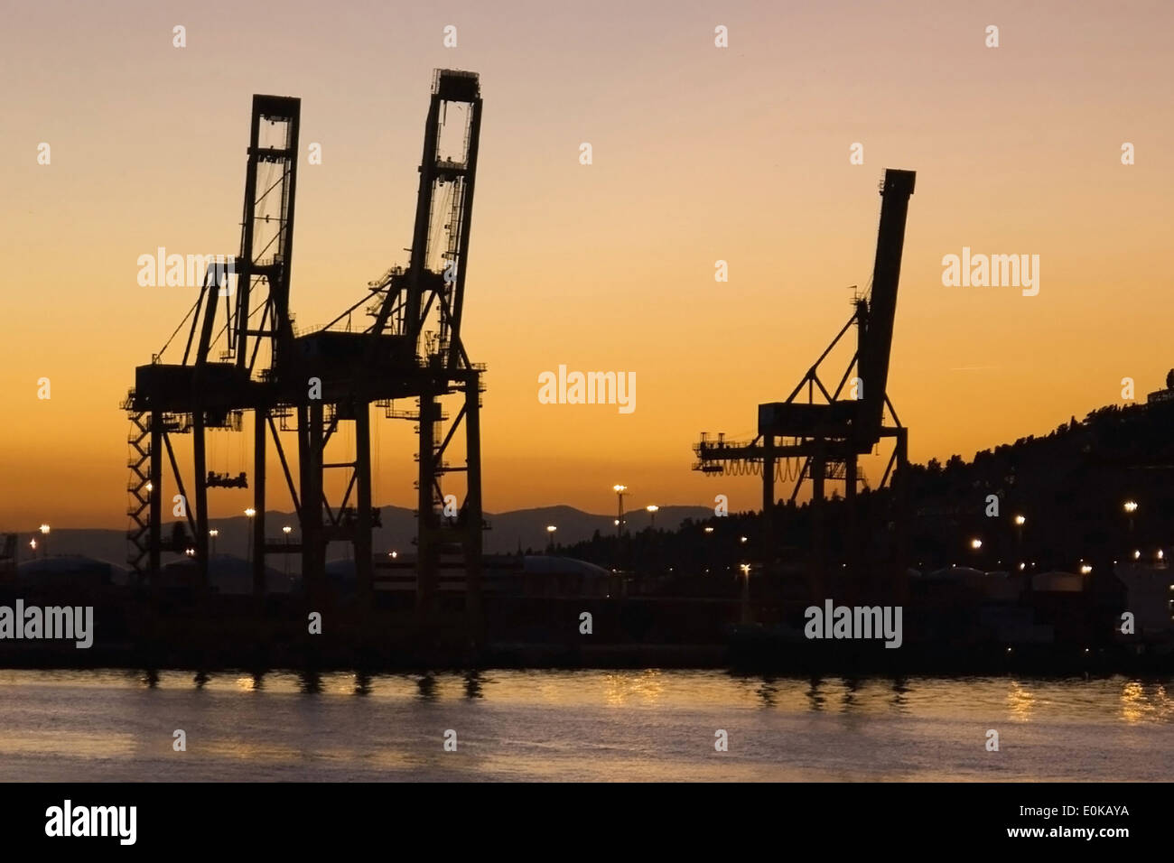Cargo cranes on the harbour of Barcelona at sunset, Catalonia. Stock Photo