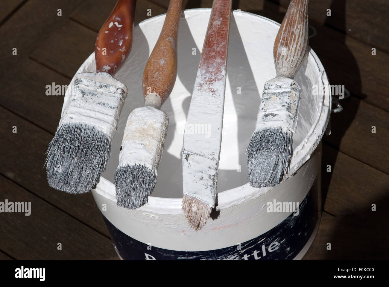 A professional painter and decorators paint brushes on the edge of a