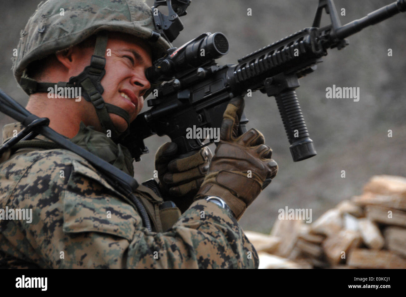 U.S. Marine 1Lt. Brian Bulaud looks through his scope while providing security at a Afghan National Army Tactical Control Point Stock Photo