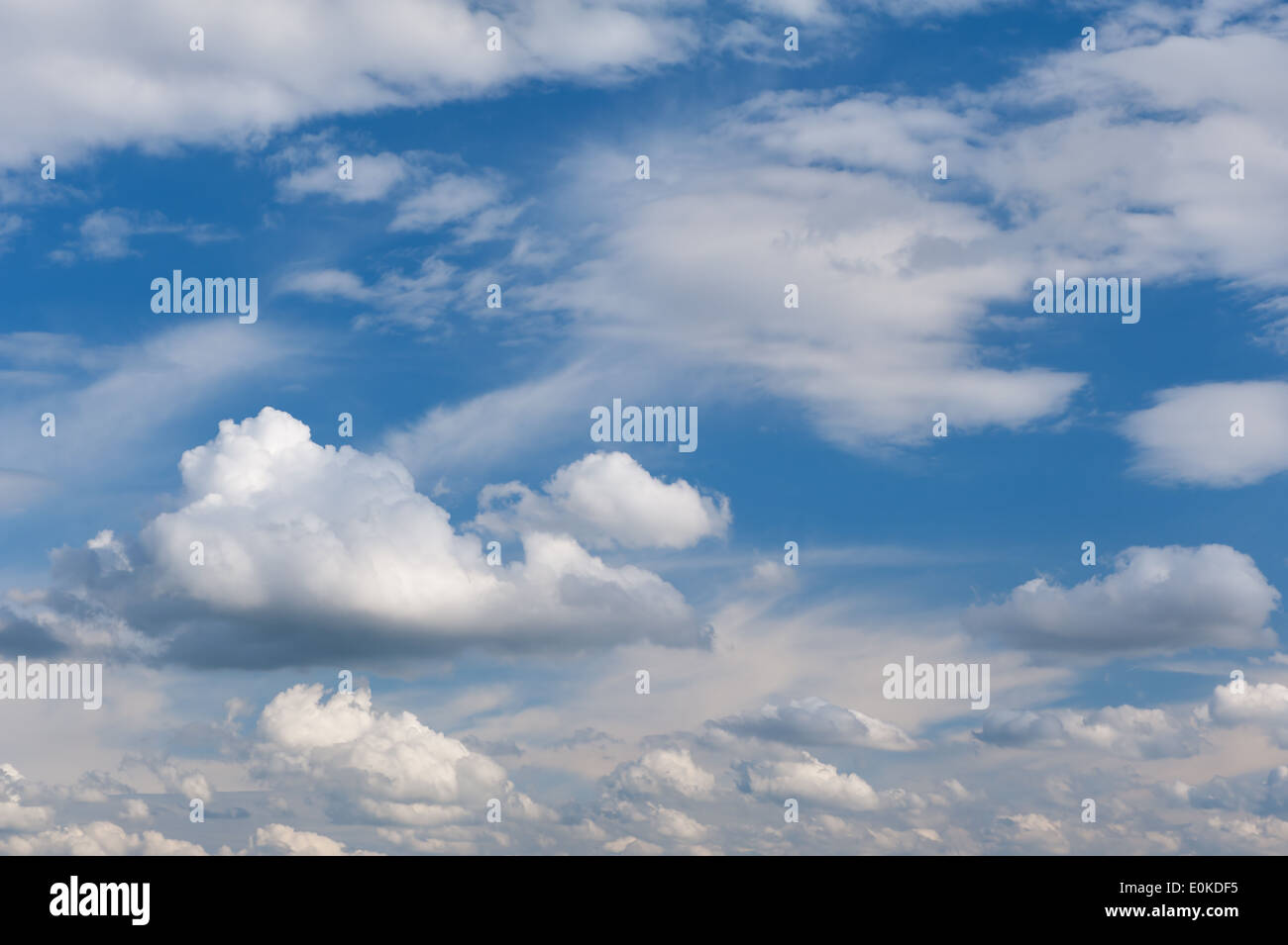 Sunny cirrus and cumulus cloudscape mix on blue sky, clouds in good weather in horizontal orientation, nobody. Stock Photo