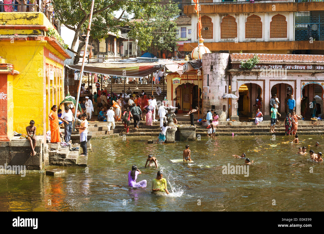 People bathe in the holy water of the Godavari River at Ram Kund (Ganga Ghat). Stock Photo