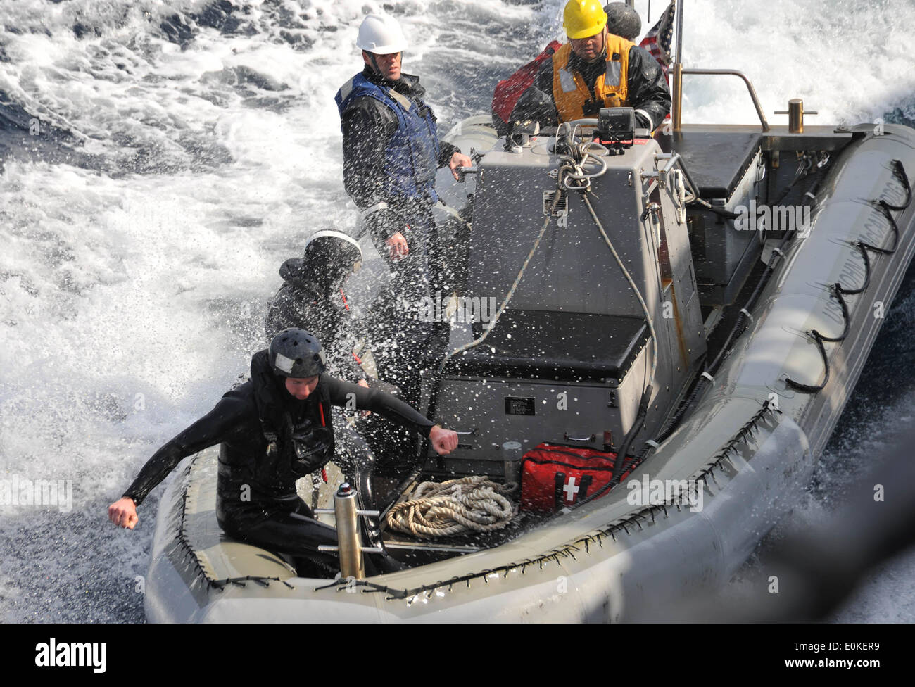 Sailors assigned the guided-missile destroyer USS John S. McCain steer their rigid-hull inflatable boat alongside the ship afte Stock Photo