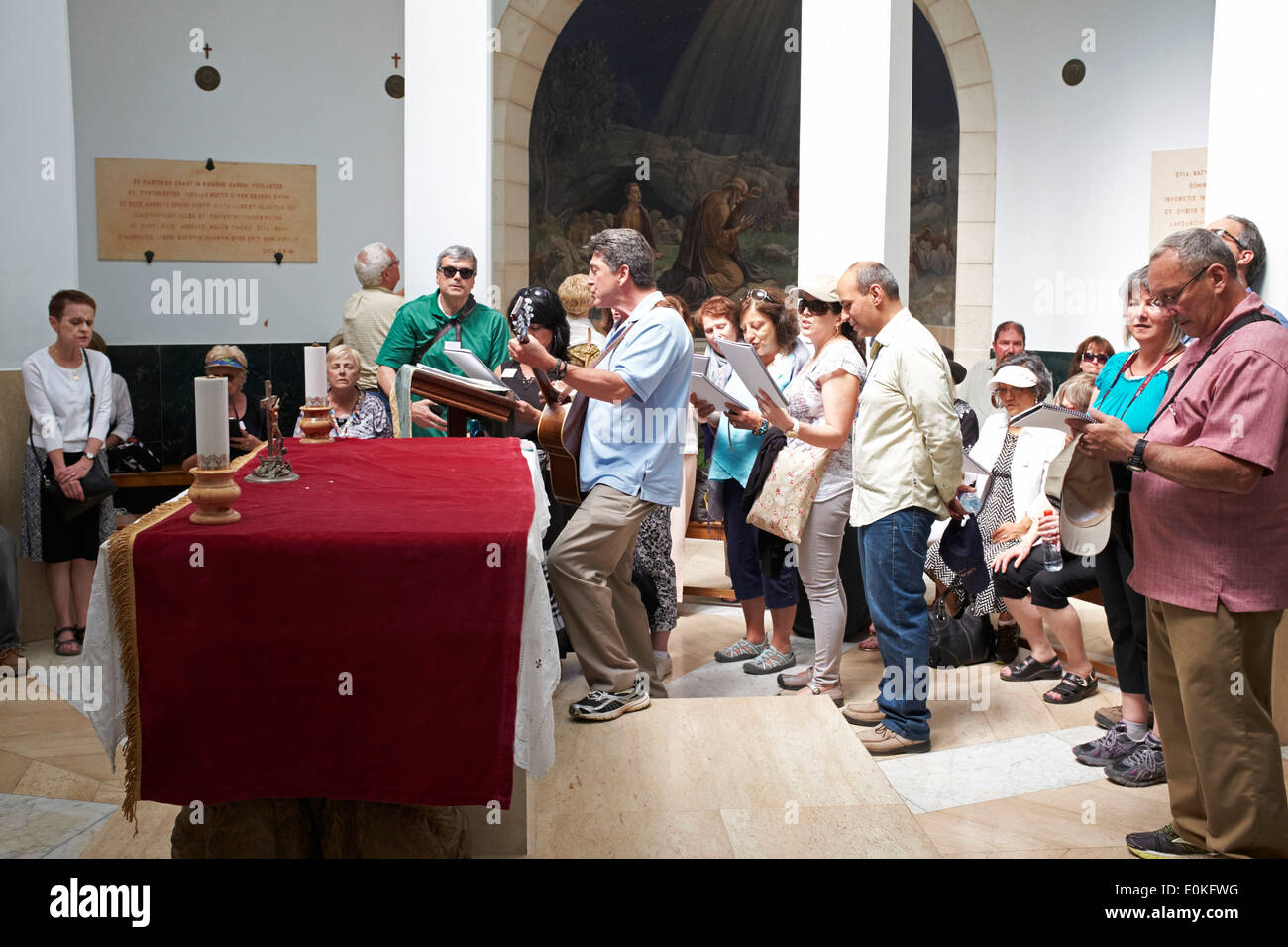 Group singing inside The Church of the Shepherds, Bethlehem, Israel Stock Photo