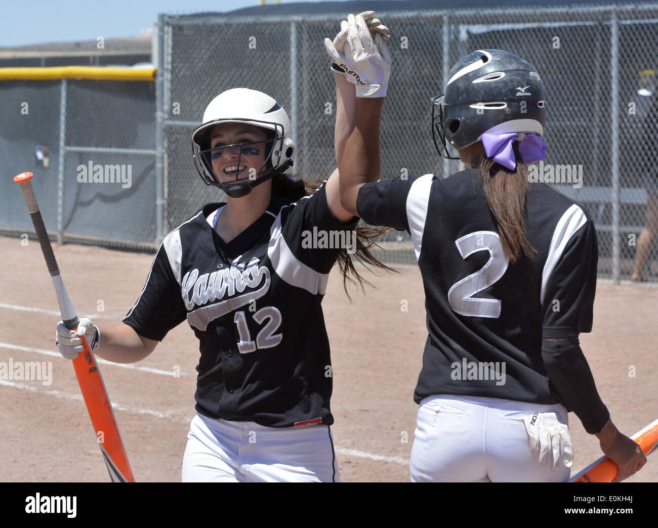 Usa. 14th May, 2014. SPORTS -- Volcano Vista's Victoria Castro, 2, gives a high five to Courtney Love, 12, who just score during the 5A state softball game against Cibola at Cleveland High School on Thursday, May 15, 2014.Volcano Vista won 9-5. © Greg Sorber/Albuquerque Journal/ZUMAPRESS.com/Alamy Live News Stock Photo