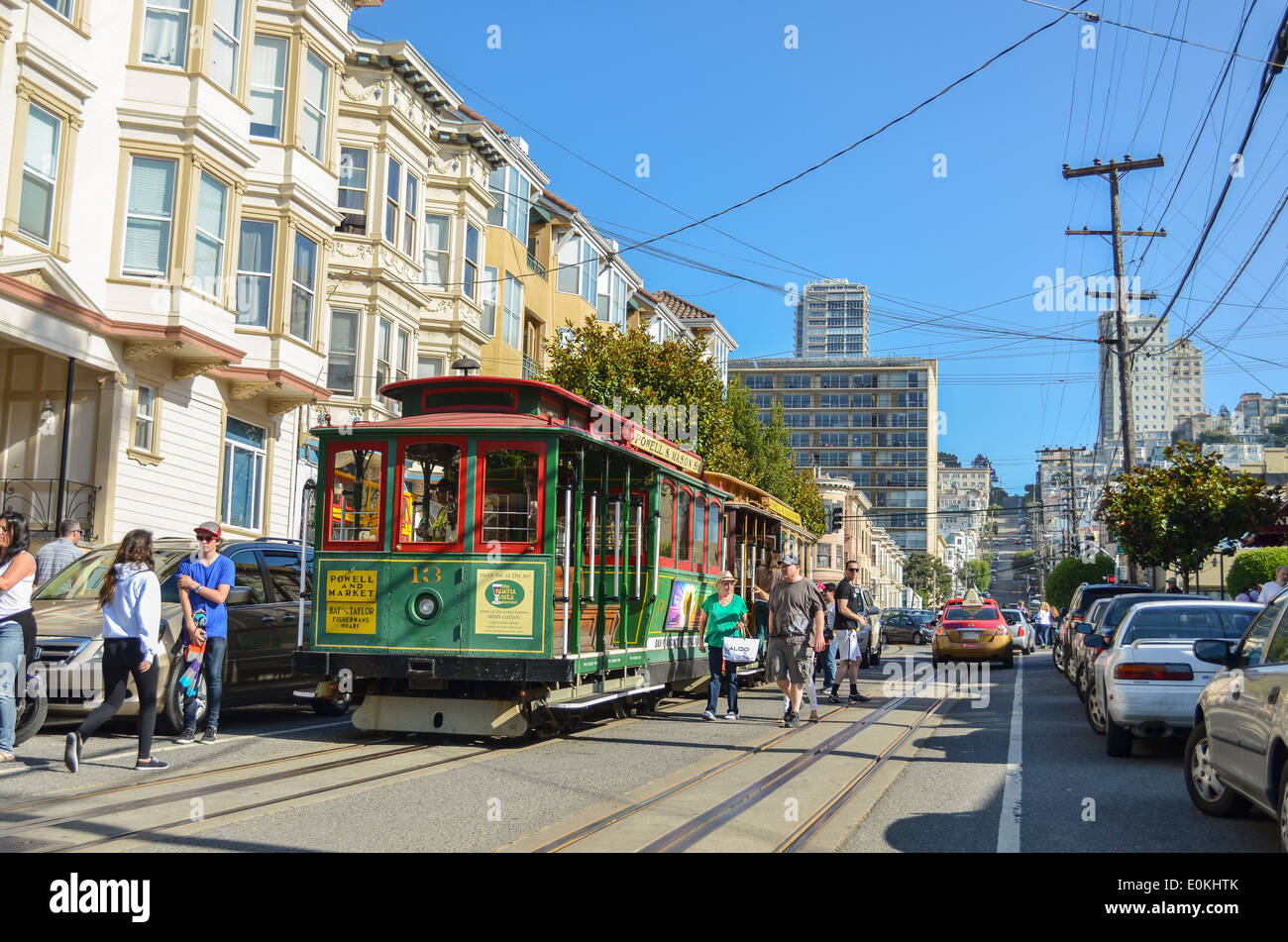 Cable car on halt on a street in San francisco surrounded by tourists Stock Photo