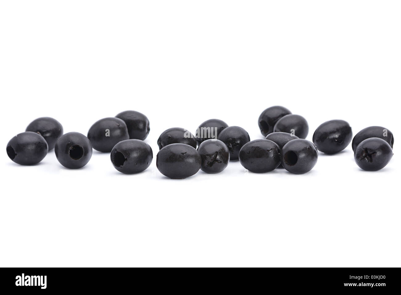 Marinated black pitted olive closeup isolated on white background Stock Photo