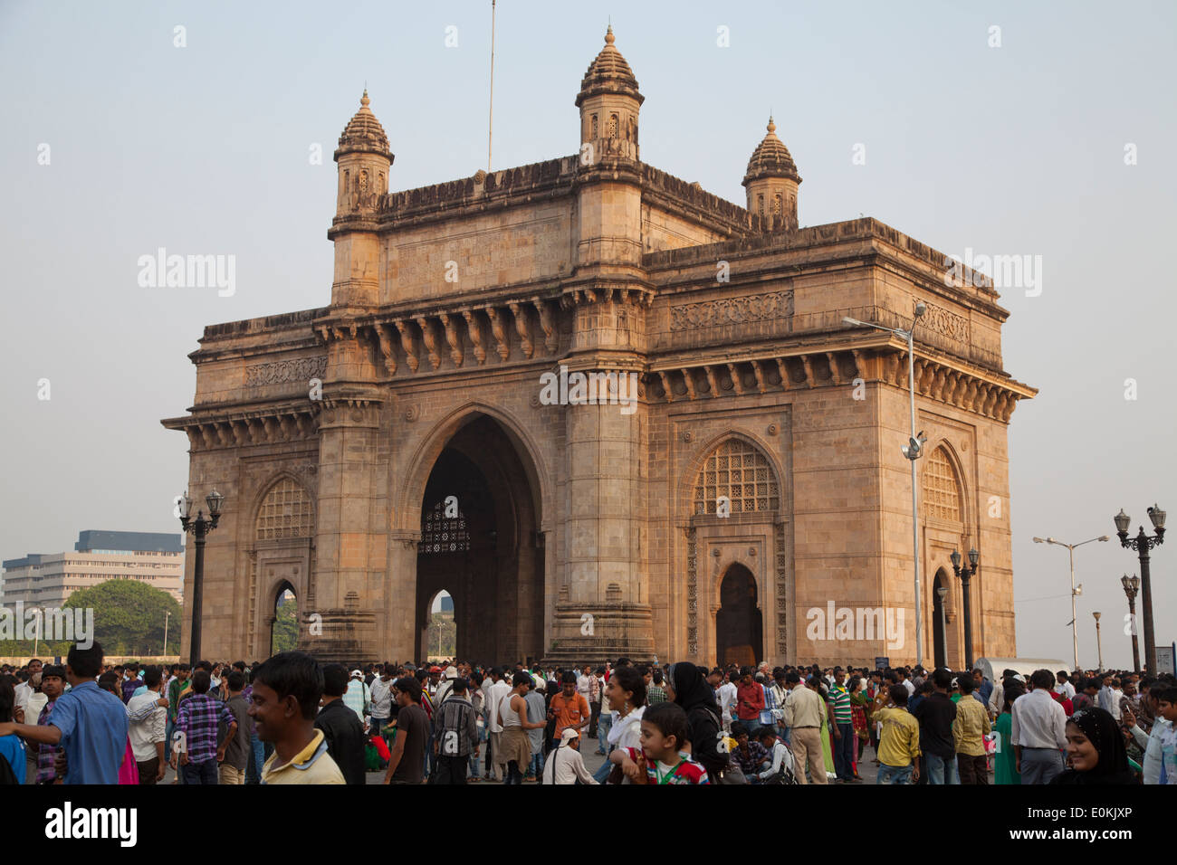 Tourists enjoy sunset at the Gateway of India, Mumbai, which was built for the royal visit of King George V in 1911. Stock Photo