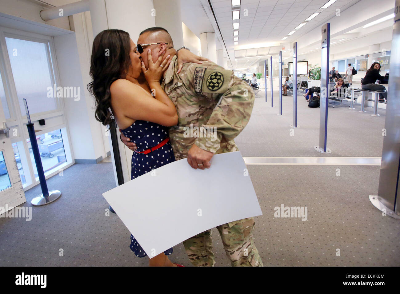 Ontario, CA, USA. 13th May, 2014. Sgt. Julian Cesneros kisses his wife after returning from Afghanistan at the airport in Ontario, California. Sgt. Cesneros, a soldier with the 349th Quartermaster Company in the 40th Infantry Division of the California National Guard, had completed two back to back deployments and had been away from his family for 11 months this time around. Applause broke out in the airport terminal when the two reunited. © Krista Kennell/ZUMAPRESS.com/Alamy Live News Stock Photo