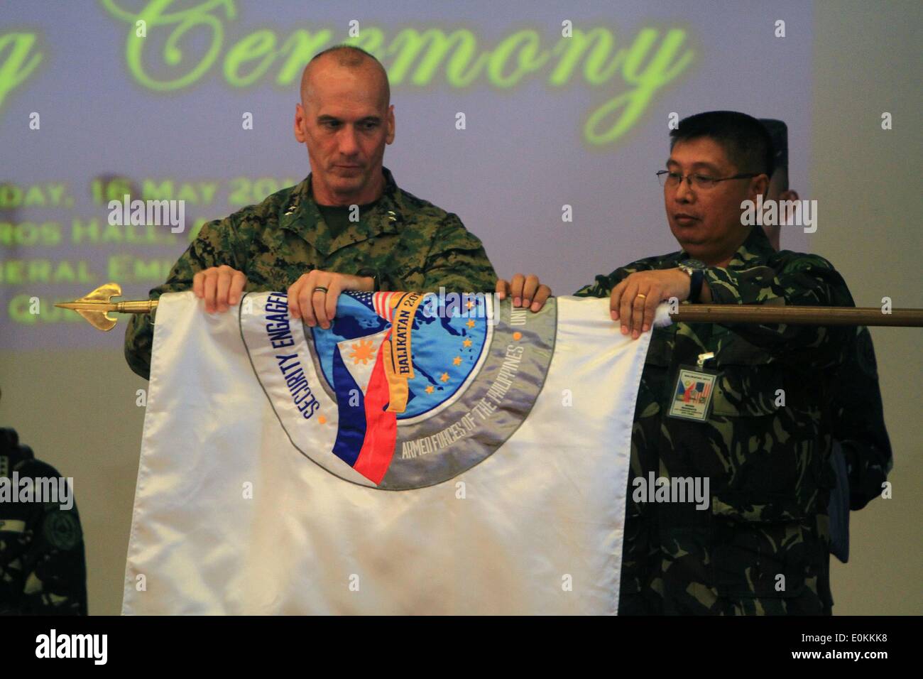 Quezon City, Philippines. 16th May, 2014. Deputy Commander of U.S. Marine Corps Forces Pacific Major General Richard Simcock II (L) and BK14 Exercise Director for Philippines Gen. Emeraldo Magnaye roll up the Balikatan Flag during the closing ceremony of the U.S.-Philippines military exercise dubbed as Balikatan inside Camp Aguinaldo in Quezon City, the Philippines, May 16, 2014. The 30th annual joint military drill dubbed as Balikatan involved 3,000 Philippine soldiers and 2,500 U.S. soldiers. © Rouelle Umali/Xinhua/Alamy Live News Stock Photo