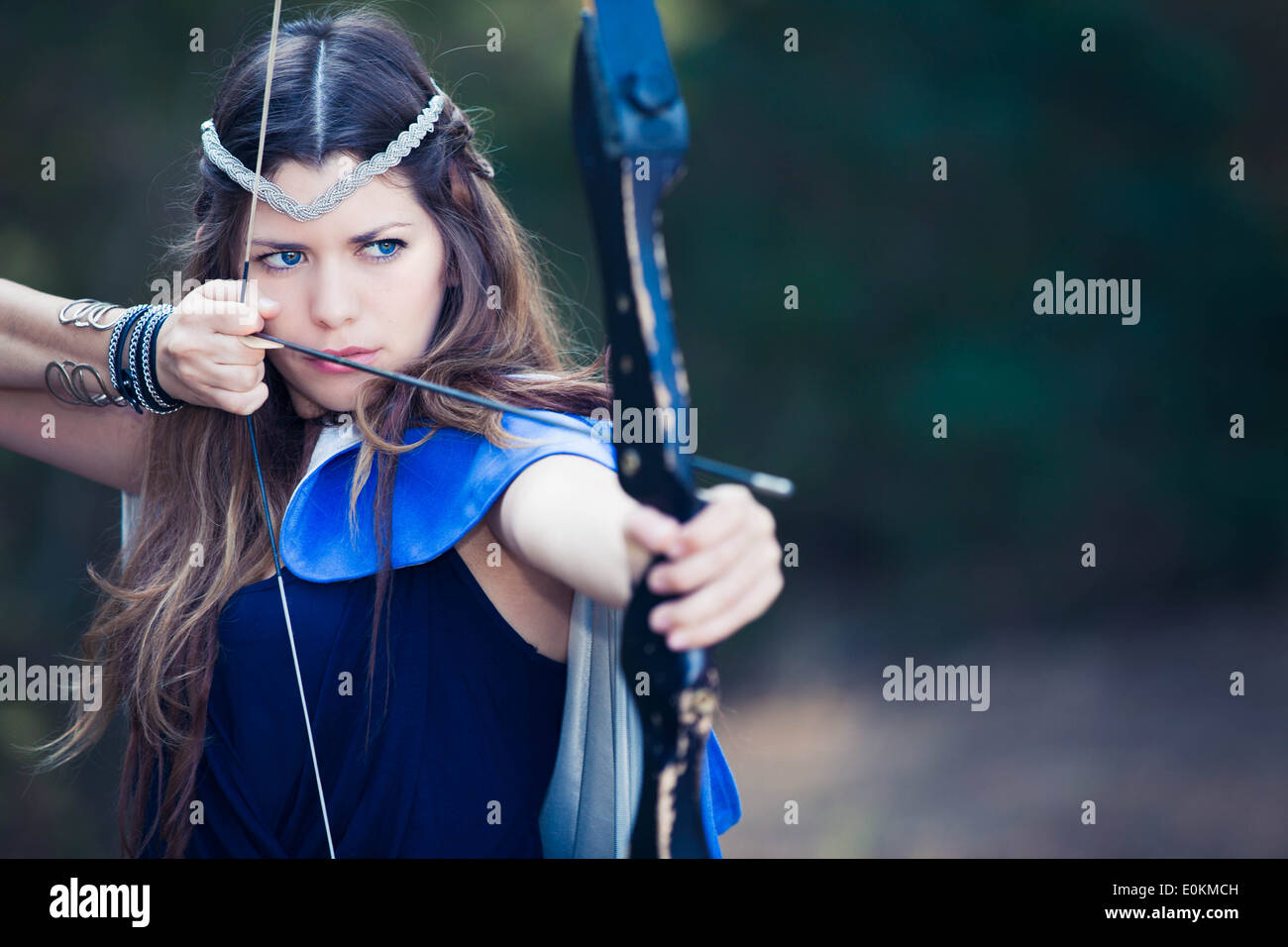 fictional forest hunter girl with bow and arrow Stock Photo Alamy