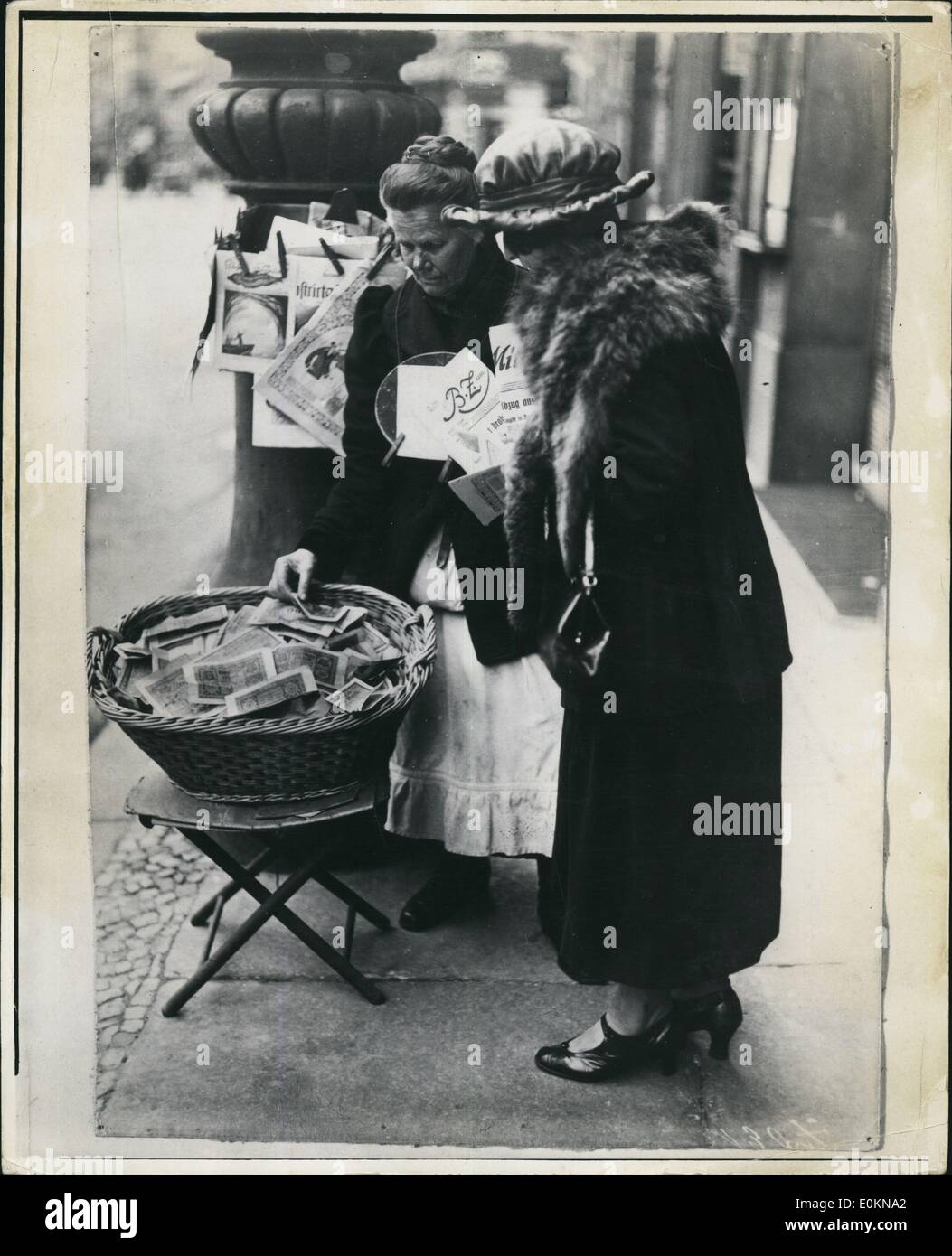Jan. 1, 1920 - Inflation In Germany After WWI: The German Mark fell to such a low level during the inflation of 1923 that a newspaper selling woman had to keep her change in a market basket. Stock Photo