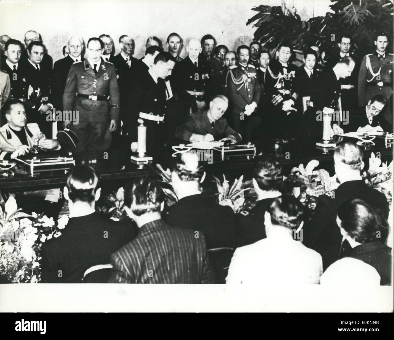 Sep. 09, 1940 - Tokyo joins Berlin and time: A scene of historic importance enacted in Adolf Hitler's Berlin Chancellery as  , seated at right, Japan's Ambassador to Germany in 1940, and Joachim von Ribbentrop, seated in , Germany's Foreign Minister, affix their signatures to the appointment political and military pact bringing Japan into closer cooperation with Germany and Italy. At left is Count Ciano. Stock Photo