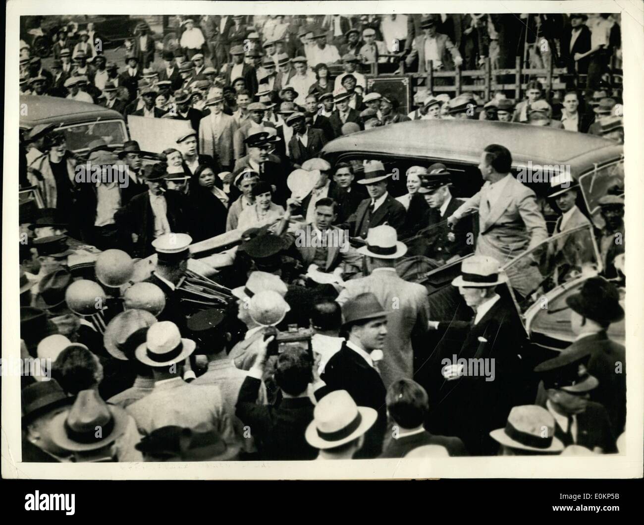 Oct. 10, 1934 - DIZZY DEAN WELCOMED HOME Jerome Herman (Dizzy) Dean, elder of the brother who pitched the St. Louis Cardinals into a world championship, salutes the huge crowd of St. Louis MO. admirers as he arrives back in the city from Detroit. Dizzy, seated in the car Stock Photo