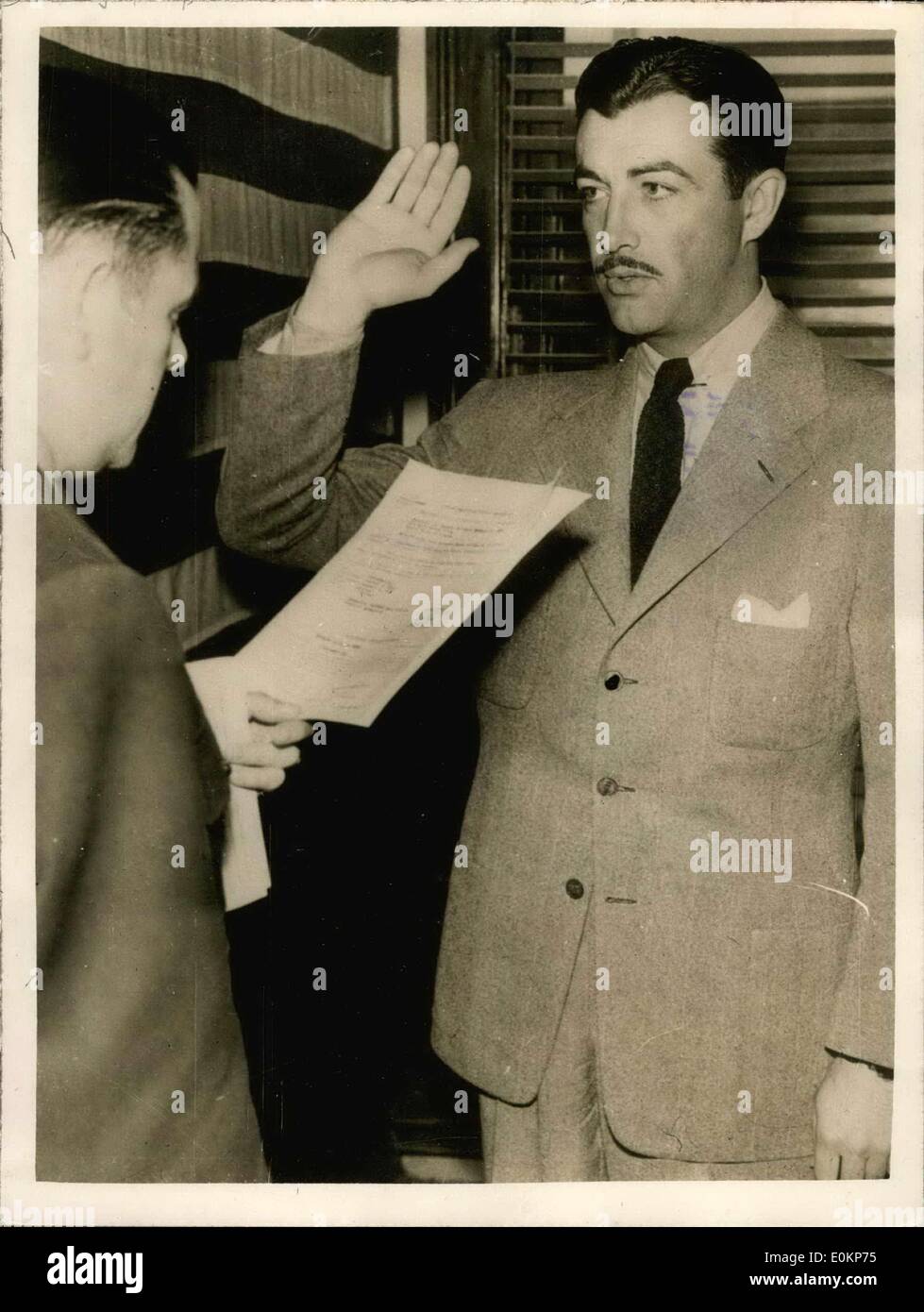 Mar. 16, 1943 - Robert Taylor joins U.S. army arm.: Photo shows film star Robert Taylor showing as Lt. Wallace Treu Administeredthe oath making the actor Lieutenant (J.G.) in U.S. Naval Air Force. Taylor will start training as Ferry Pilot or instructor. Stock Photo