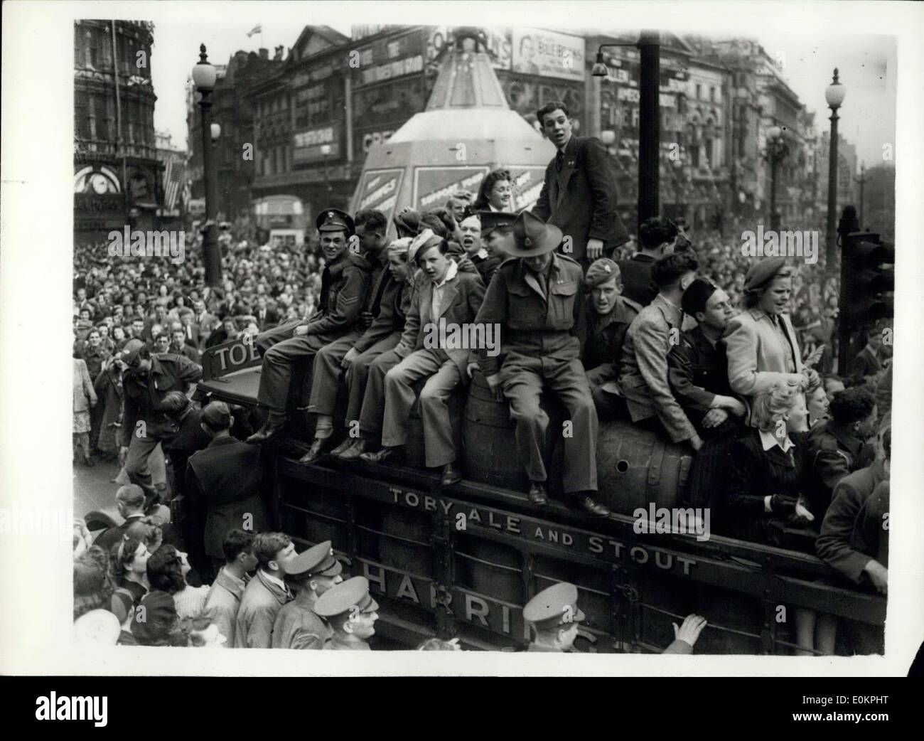 May 08, 1945 - Victory Scenes In Piccadilly Roll Out The Barrell: A van-load of beer passing through Piccadilly Circus. The expressions of some of the men sitting on top suggest they they have tasted a drop. Stock Photo