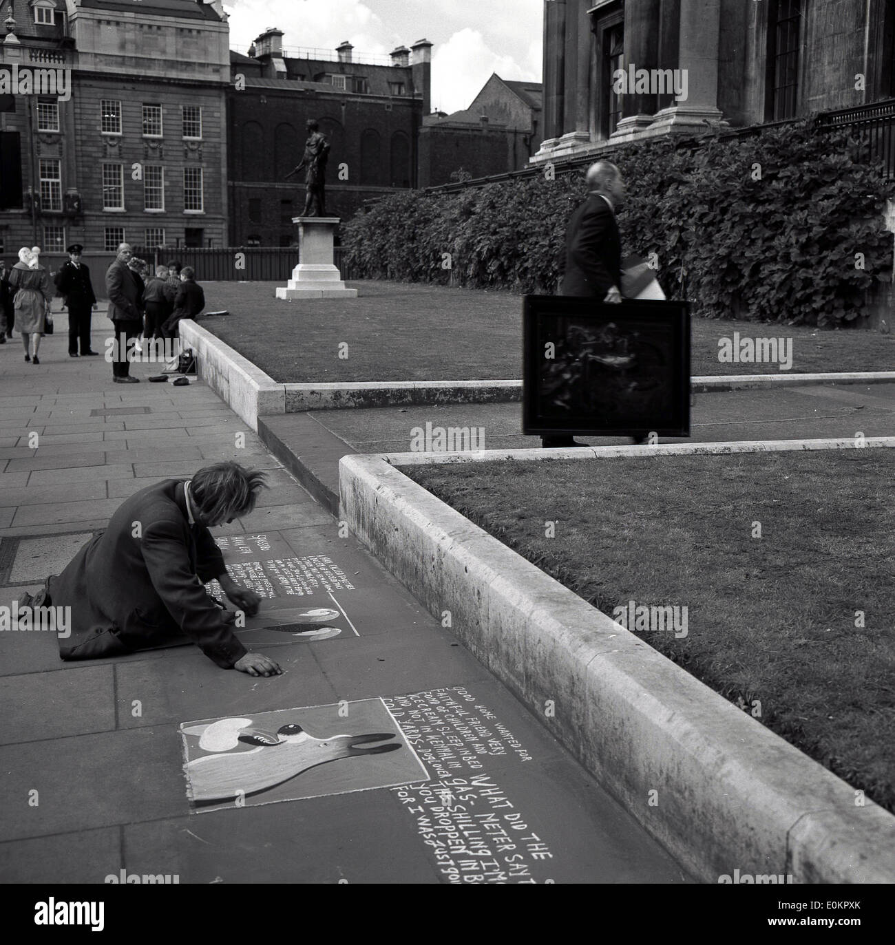 1950s historical picture of a pavement artist at work, Lincoln Inn Fields, London, England. Stock Photo